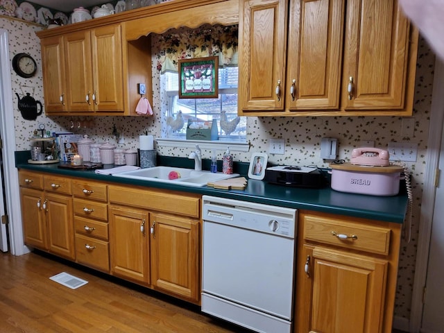 kitchen featuring dishwasher, light hardwood / wood-style floors, and sink