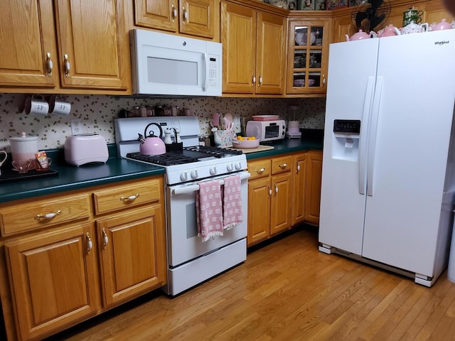 kitchen with white appliances and light wood-type flooring