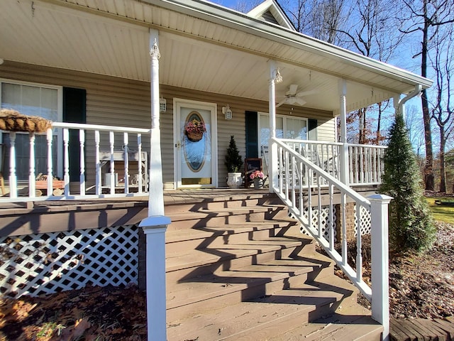 entrance to property featuring a porch and a ceiling fan