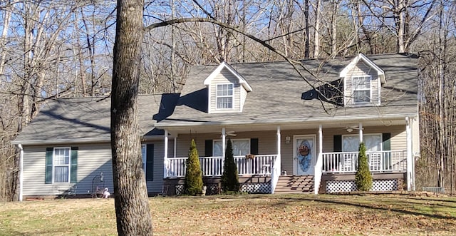 cape cod-style house with a porch, a front yard, roof with shingles, and ceiling fan