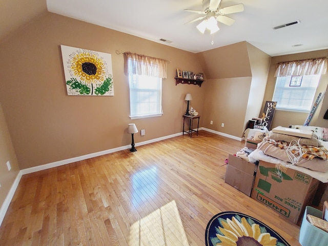 interior space with visible vents, baseboards, and wood finished floors