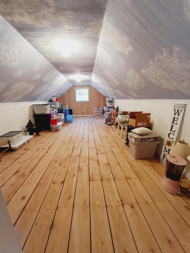 bonus room featuring vaulted ceiling and wood finished floors