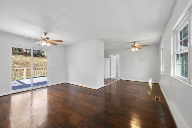 empty room with ceiling fan and dark wood-type flooring