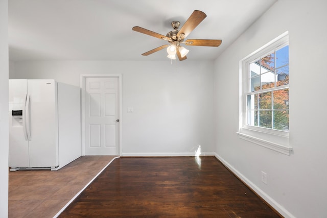 unfurnished room with ceiling fan and dark wood-type flooring