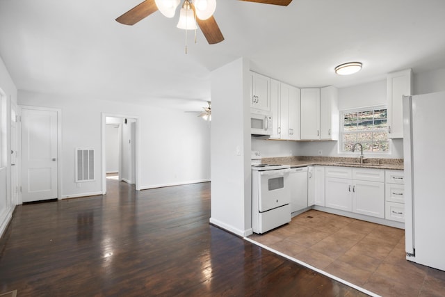 kitchen featuring white cabinetry, white appliances, and sink