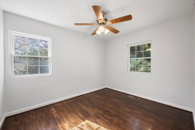 spare room with wood-type flooring, ceiling fan, and a healthy amount of sunlight