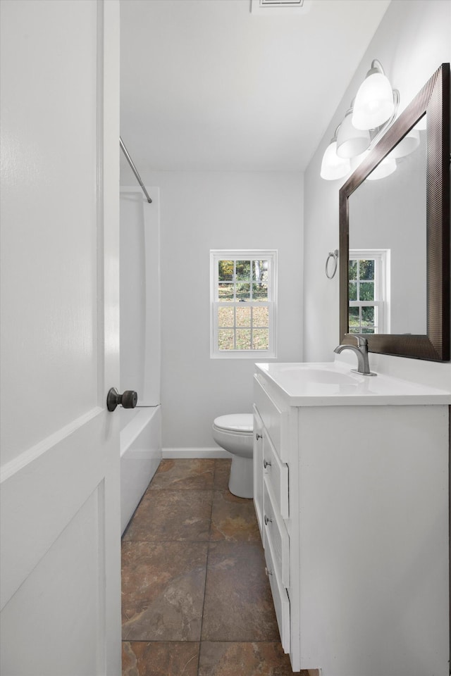 full bathroom with washtub / shower combination, vanity, and toilet