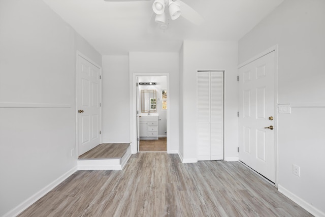 foyer entrance featuring ceiling fan and light hardwood / wood-style floors