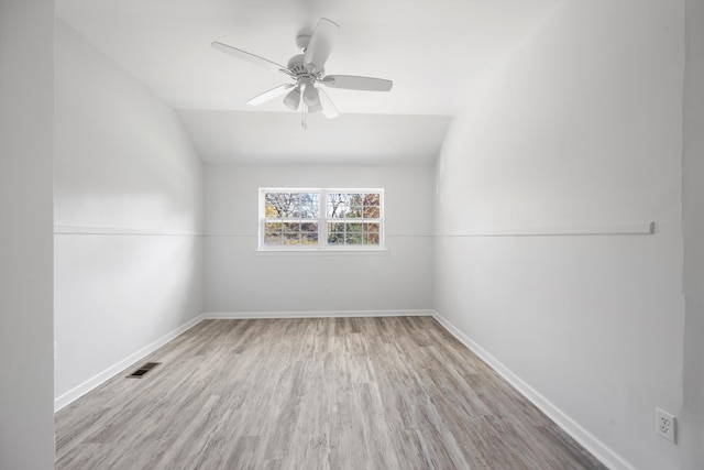 unfurnished room with light hardwood / wood-style floors, vaulted ceiling, and ceiling fan