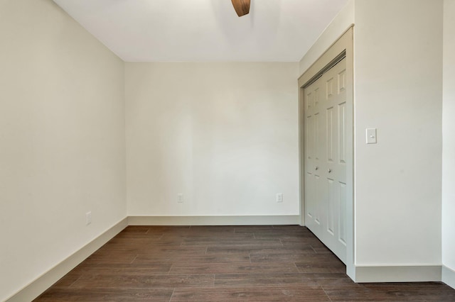 unfurnished bedroom with dark hardwood / wood-style floors, a closet, and ceiling fan