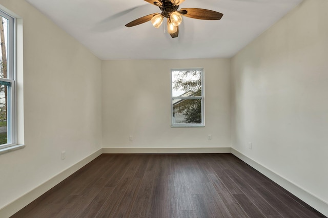 empty room featuring ceiling fan and dark hardwood / wood-style flooring