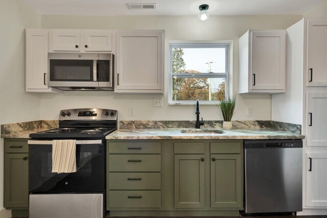 1024 Hurst St, East Ridge, TN 37412 - kitchen featuring stainless steel appliances, green cabinetry, and a sink