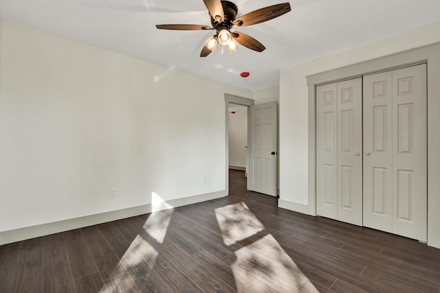 unfurnished bedroom featuring a closet, ceiling fan, and dark hardwood / wood-style flooring