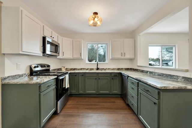 kitchen with sink, white cabinetry, stainless steel appliances, and a healthy amount of sunlight