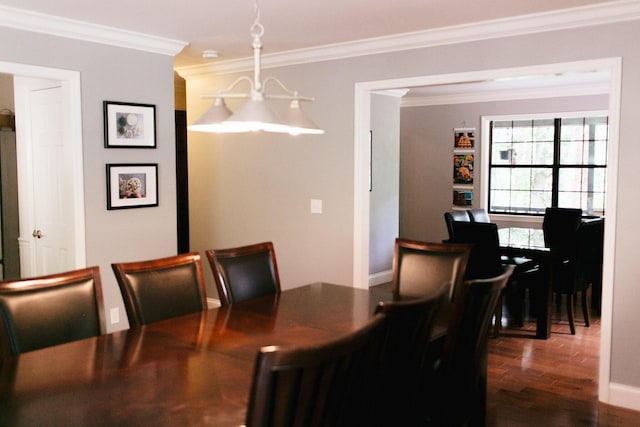 dining space with crown molding and dark hardwood / wood-style floors