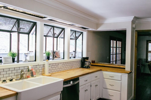 kitchen featuring wooden counters, white cabinets, ornamental molding, sink, and dishwasher