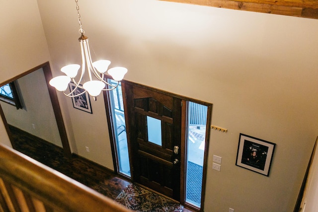 entrance foyer featuring a chandelier and lofted ceiling