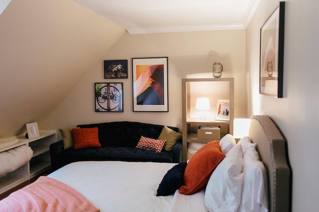 bedroom featuring lofted ceiling and crown molding