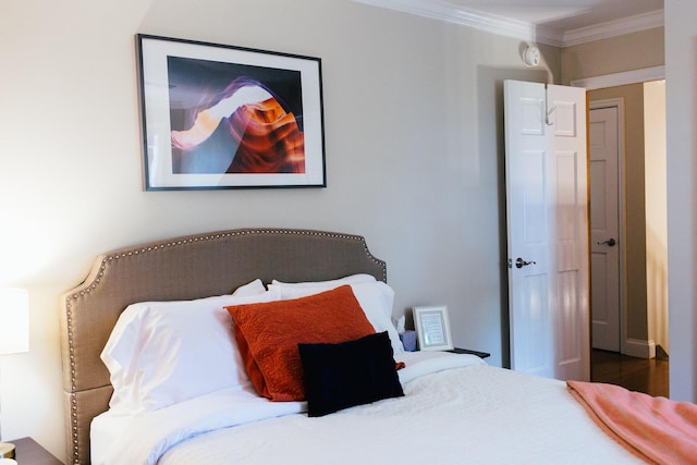 bedroom with wood-type flooring and ornamental molding