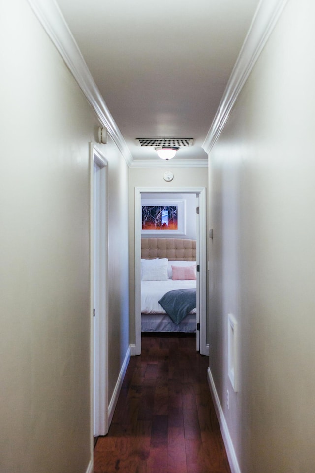 hallway with dark hardwood / wood-style floors and ornamental molding