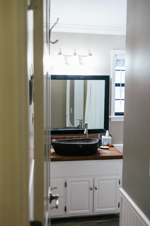 bathroom featuring vanity and ornamental molding