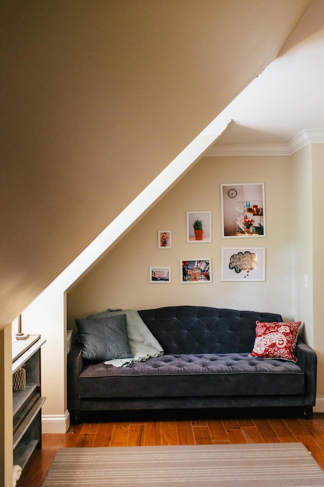 living room featuring a skylight, crown molding, and hardwood / wood-style flooring