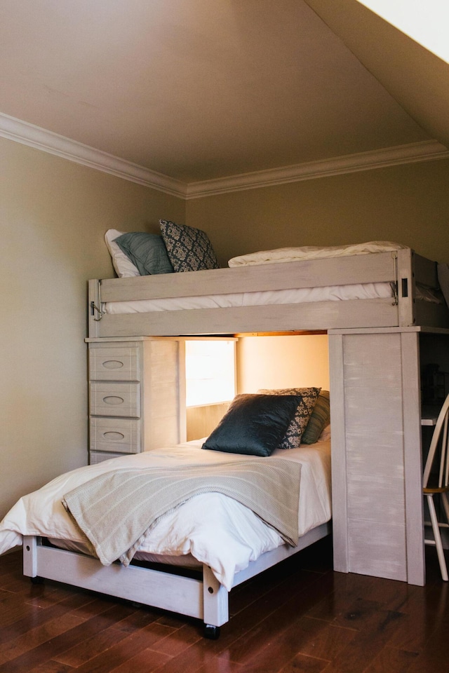 bedroom with dark hardwood / wood-style flooring and ornamental molding