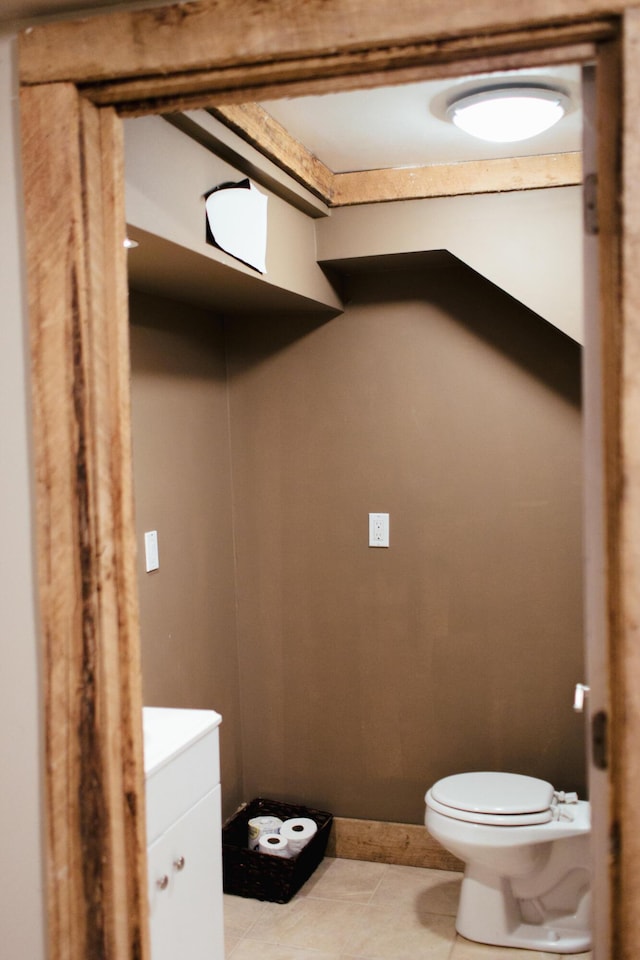 bathroom featuring tile patterned floors, vanity, and toilet