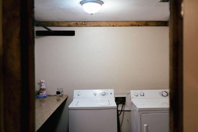 clothes washing area featuring washer and clothes dryer