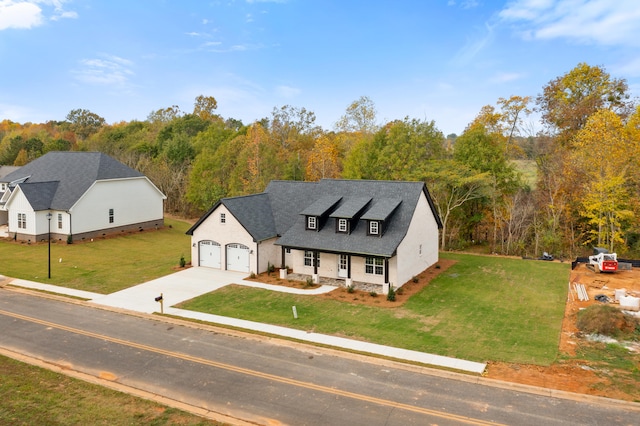 view of front of house featuring a front lawn and a garage