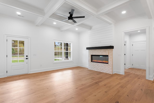 unfurnished living room featuring coffered ceiling, ceiling fan, light wood-type flooring, ornamental molding, and beam ceiling