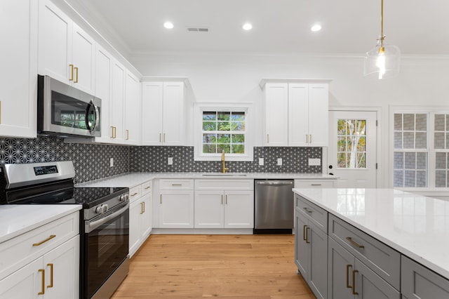 kitchen featuring gray cabinets, white cabinetry, sink, and stainless steel appliances