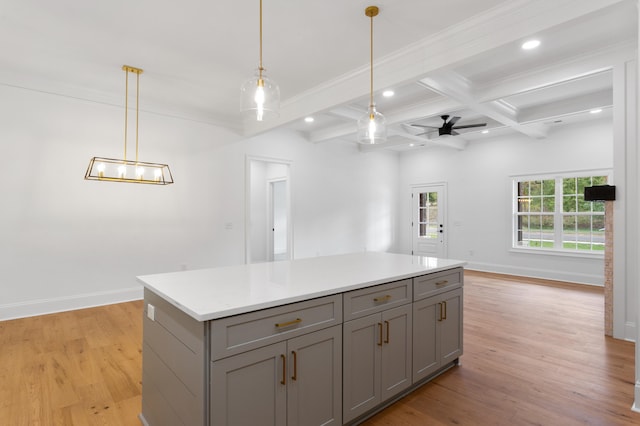 kitchen featuring gray cabinetry, ceiling fan, light wood-type flooring, beamed ceiling, and decorative light fixtures