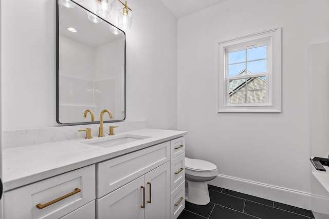 bathroom with tile patterned floors, vanity, and toilet