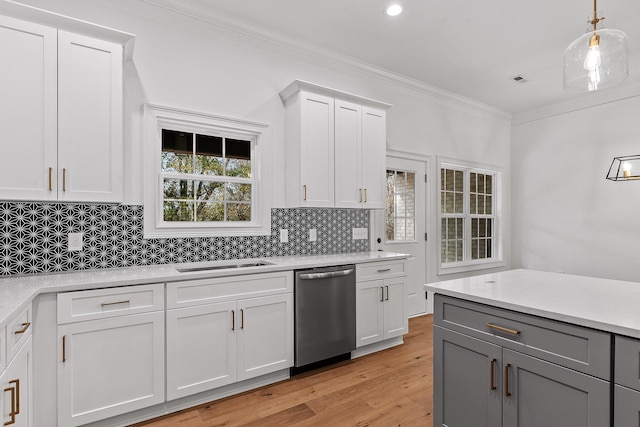 kitchen with white cabinets, light hardwood / wood-style flooring, stainless steel dishwasher, and sink