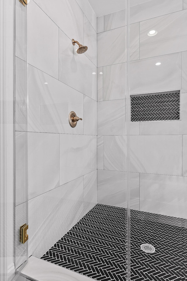 bathroom featuring a shower with shower door