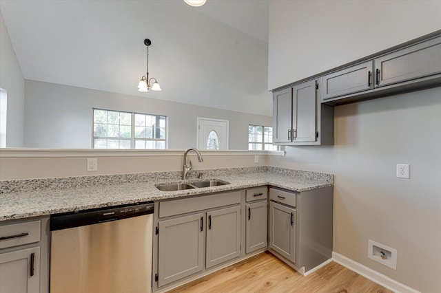 kitchen with stainless steel dishwasher, plenty of natural light, sink, and light hardwood / wood-style flooring