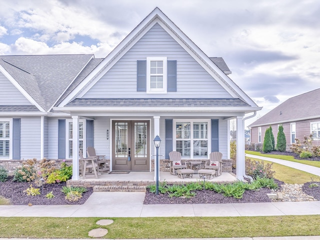 view of front of property with a porch and french doors