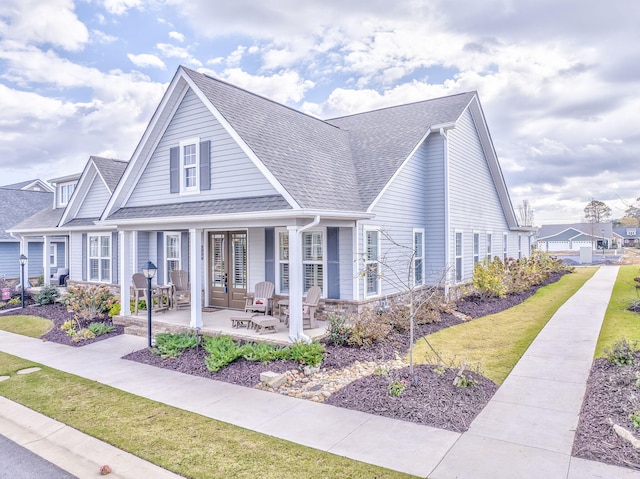 view of front of home with a front lawn and french doors