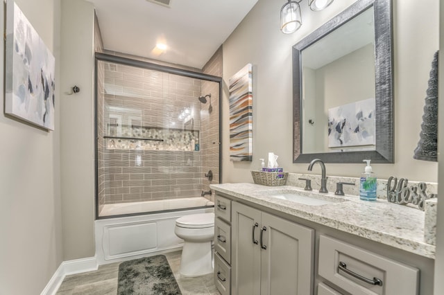 full bathroom with enclosed tub / shower combo, vanity, toilet, and wood-type flooring