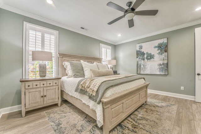 bedroom with ceiling fan, ornamental molding, and light hardwood / wood-style flooring