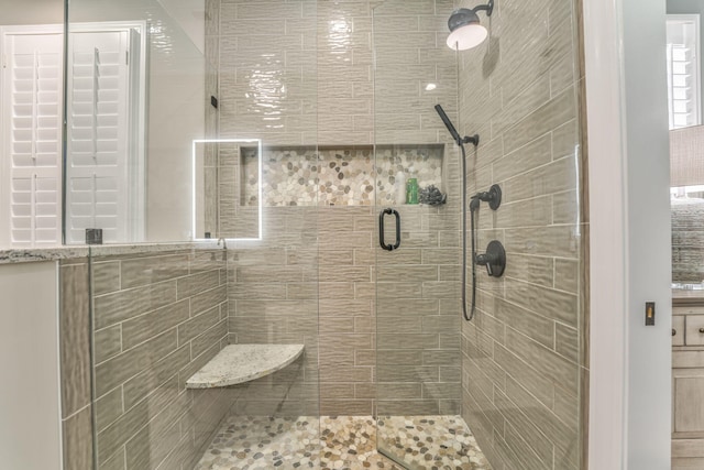 bathroom with a shower with shower door