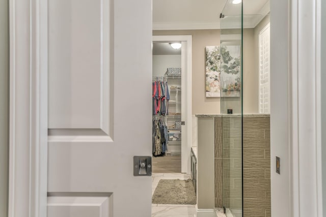 bathroom featuring an enclosed shower, vanity, and ornamental molding