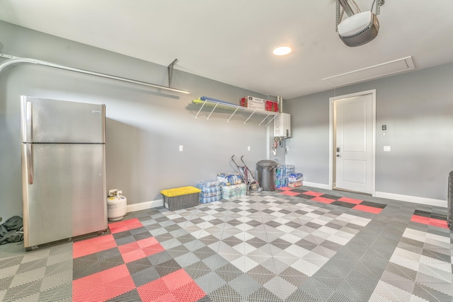 garage featuring stainless steel refrigerator and a garage door opener