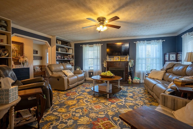 living room featuring a wealth of natural light, ceiling fan, a textured ceiling, and ornamental molding