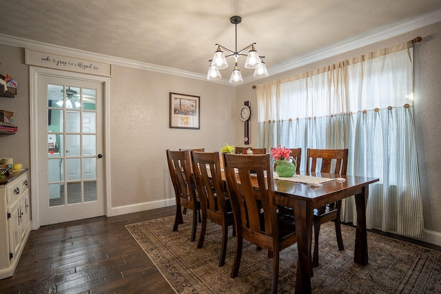 dining space featuring dark hardwood / wood-style flooring, an inviting chandelier, and crown molding