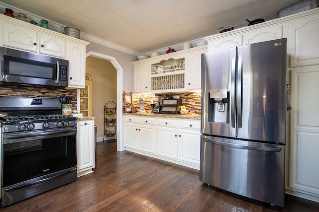 kitchen featuring decorative backsplash, light stone countertops, stainless steel appliances, crown molding, and dark hardwood / wood-style floors