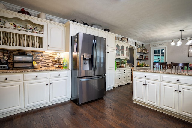 kitchen with dark hardwood / wood-style floors, stainless steel refrigerator with ice dispenser, crown molding, pendant lighting, and white cabinets