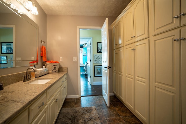 bathroom with vanity and a textured ceiling