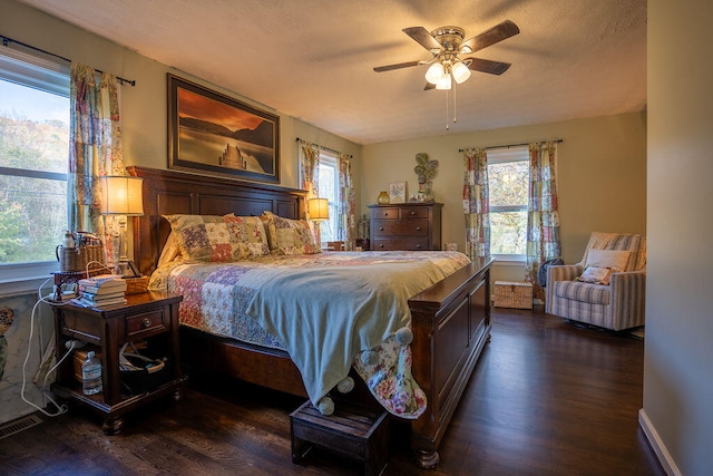 bedroom featuring ceiling fan and dark wood-type flooring